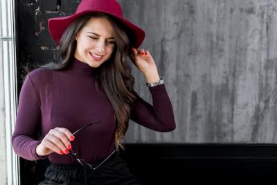 Smiling Young Woman with Pink Hat Holding Eyeglasses – Free Stock Photo for Download