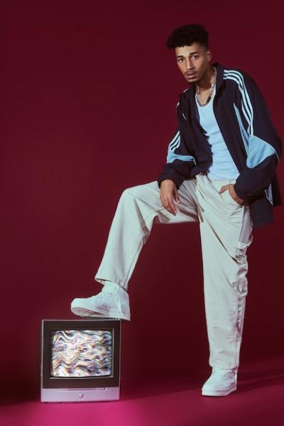 Young Man in 2000s Fashion Style Posing with TV – Free Stock Photo Download