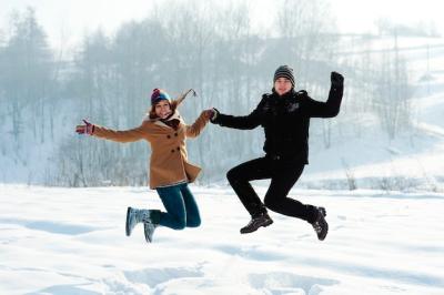 Winter Fun: Young Couple Jumping Outdoors – Download Free Stock Photo