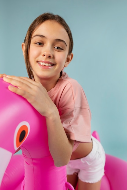 Girl Sitting on Inflatable Flamingo – Free Download, Free Stock Photo