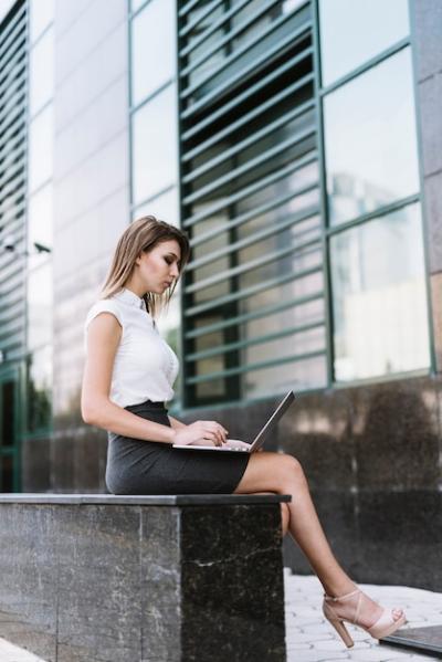 Young Businesswoman Working on Laptop Outdoors – Free Stock Photo for Download