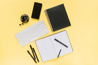 Cellphone and White Keyboard with Office Stationery on Yellow Background – Free Download