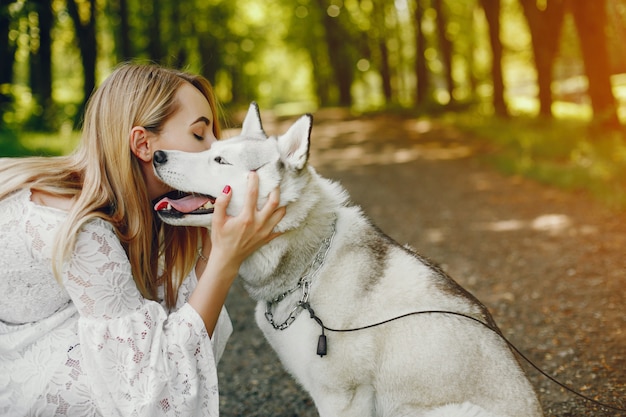 Gentle Girl with Light Hair in White Dress Playing with Dog – Free Stock Photo, Download Free