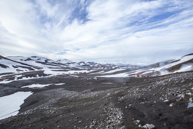 Mesmerizing Scenery of Snowy Mountains Amidst a Cloudy Sky – Free Download