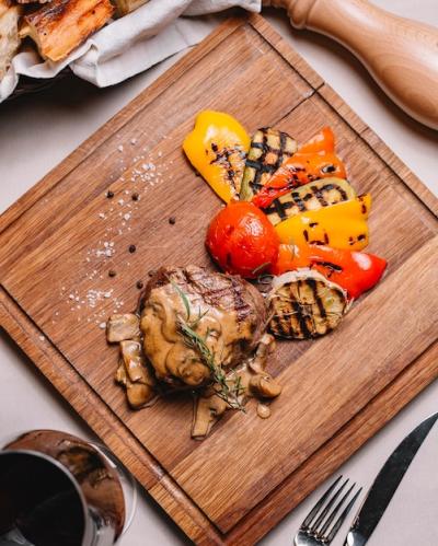 Top View of Grilled Steak with Zucchini, Bell Pepper, Tomato, Mushrooms, Sauce, Salt, and Black Pepper – Free Download