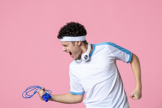 Young Male in Sport Clothes with Skipping Rope Against Pink Wall – Free Download