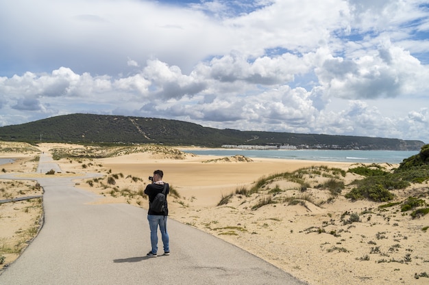 Male Photographer Walking on a Beach in Andalusia, Spain – Free Stock Photo for Download