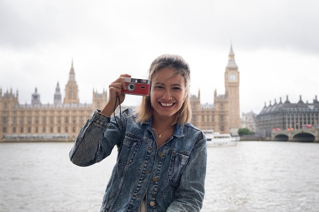 Smiley Woman Holding Camera – Free Stock Photo for Download