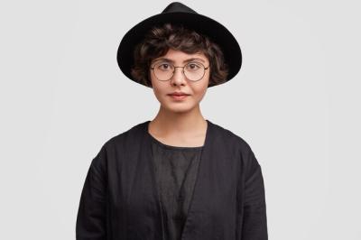 Young Woman in Black Attire and Round Glasses – Free Download