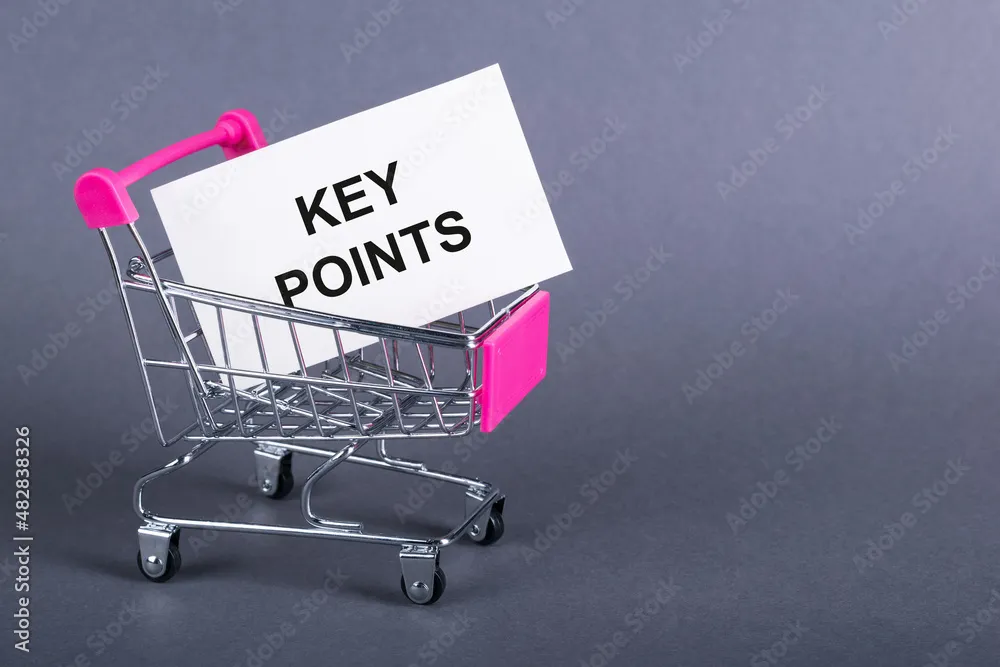 Foto Stock Shopping cart and text key points on white paper note list 