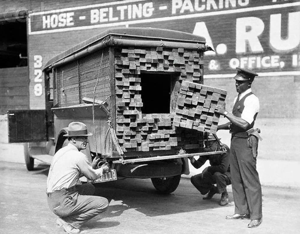 A federal agent inspects a lumber truck after smelling alcohol during 