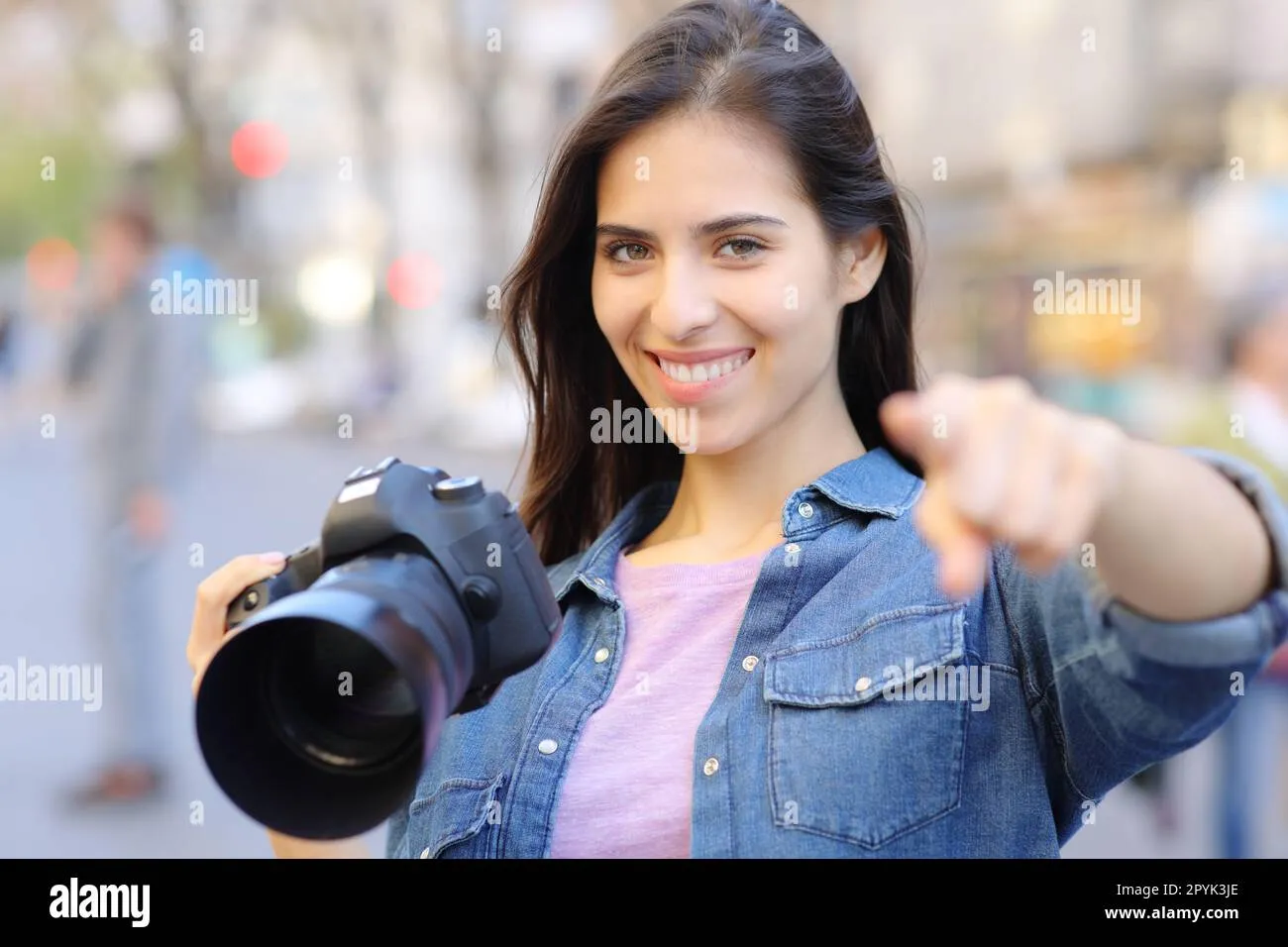 Happy photographer pointing at camera Stock Photo  Alamy