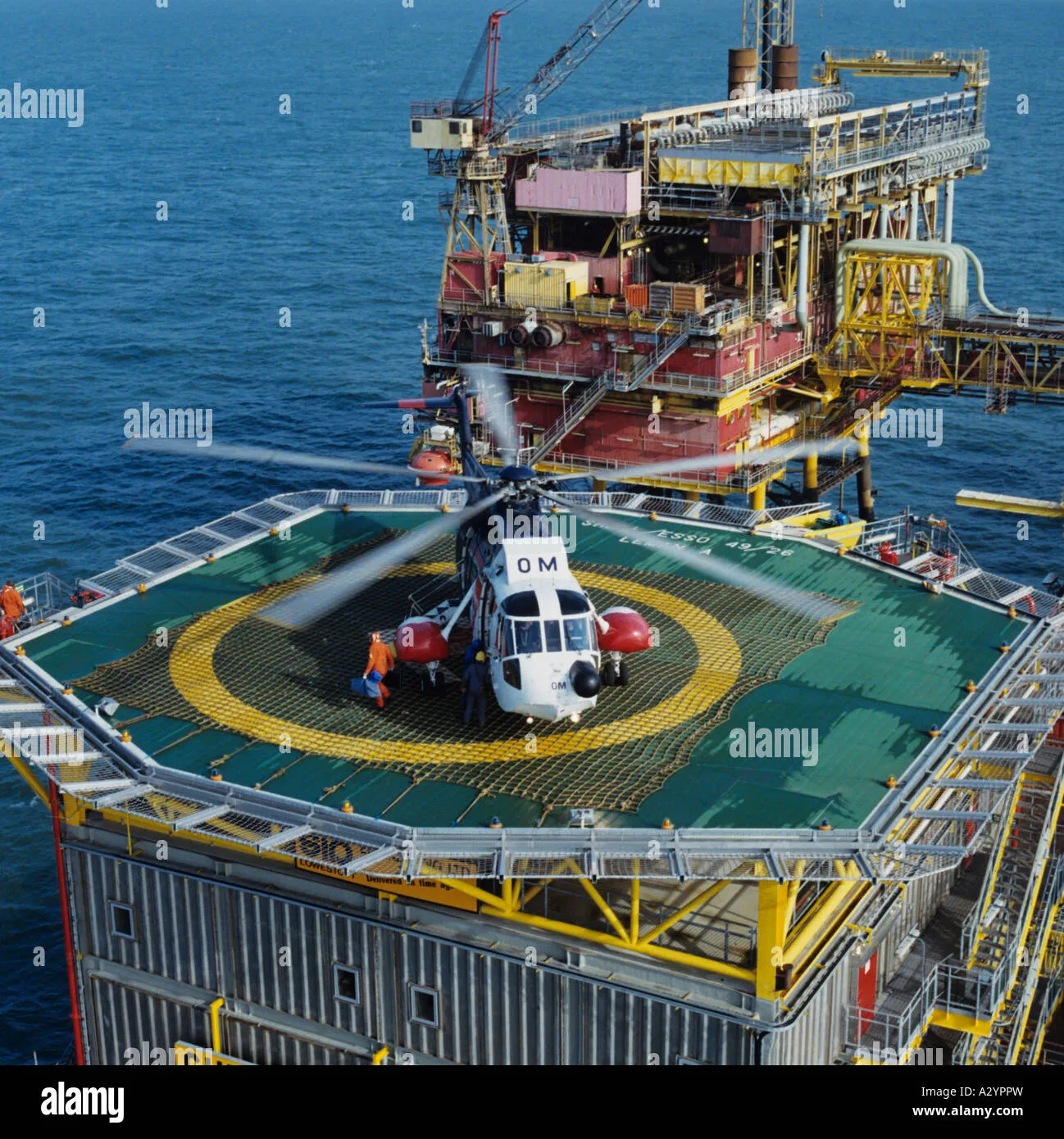 Service helicopter landing on aluminium landing pad at a gas production 