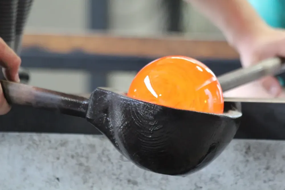 Shaping the molten glass in cherry wood paddle  Teresa  Flickr