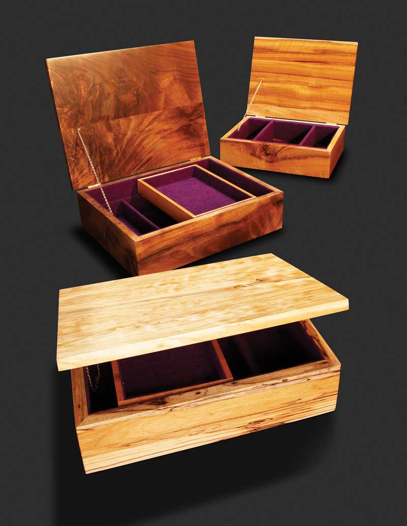 three wooden boxes with purple velvet inside and outside the lids one 