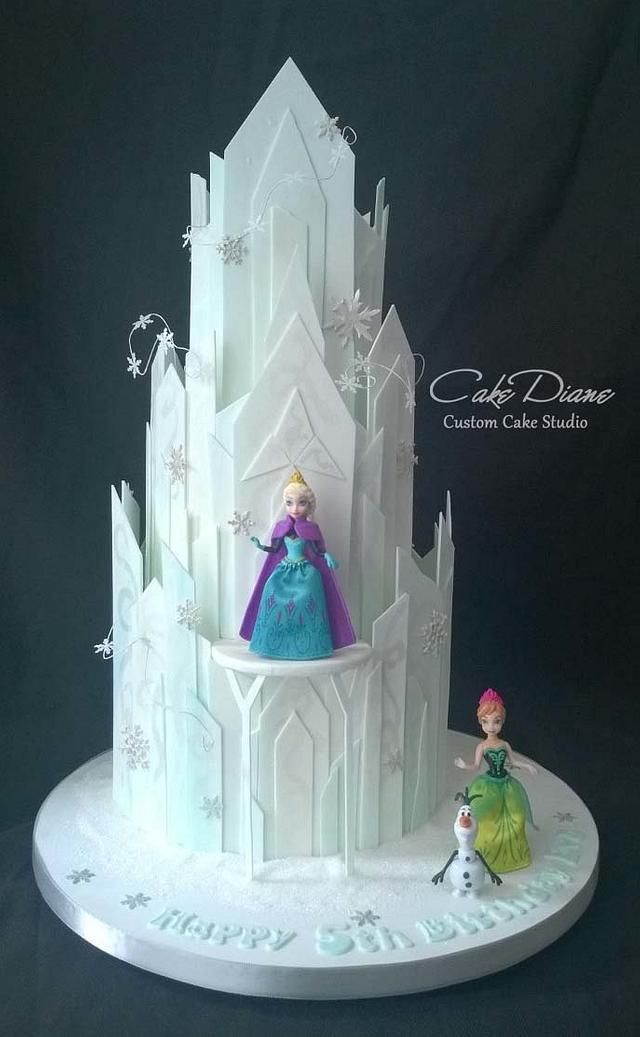 there is a cake that looks like it has frozen princess figures on top of it