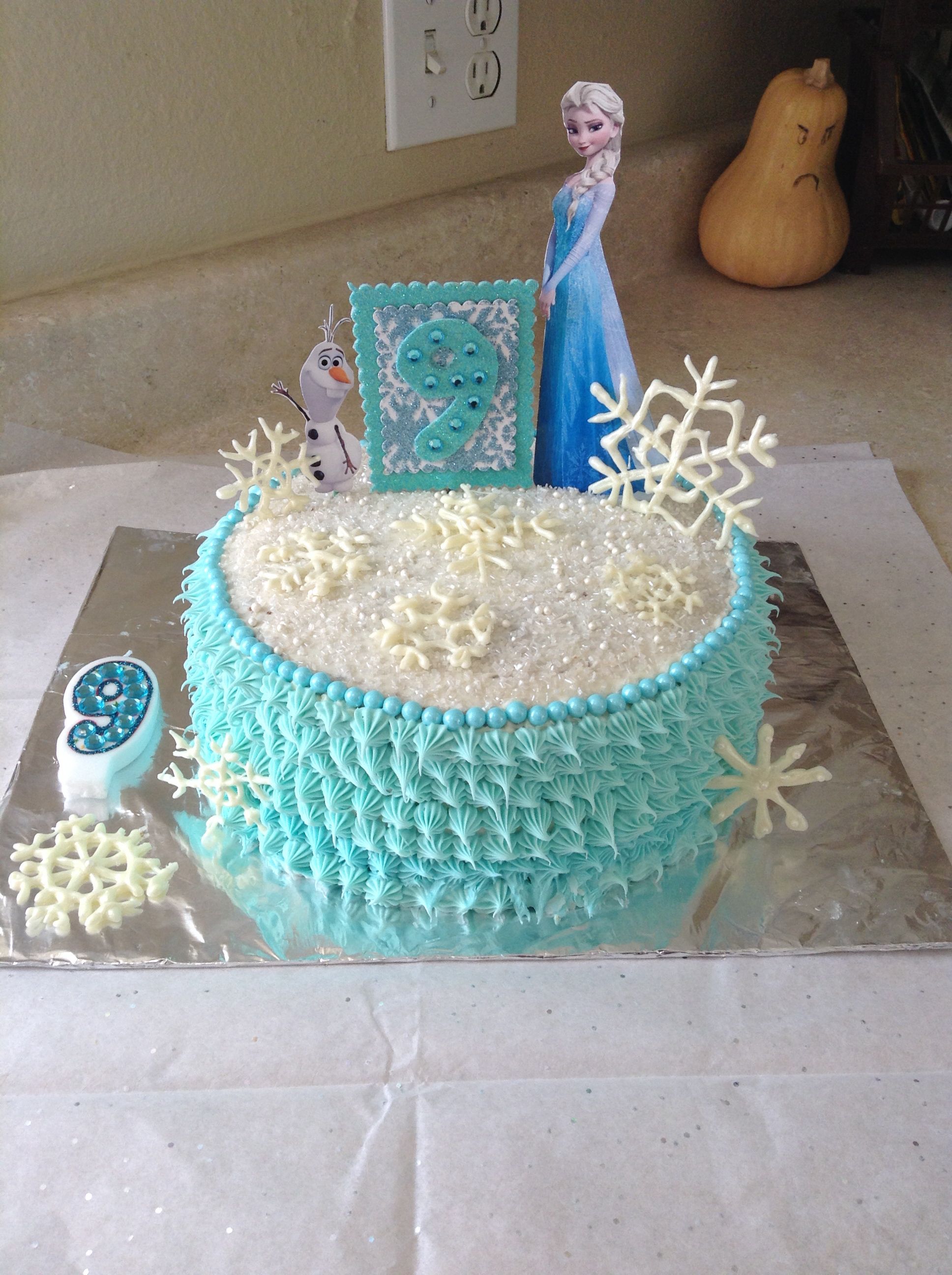 a frozen princess cake with frosting and decorations