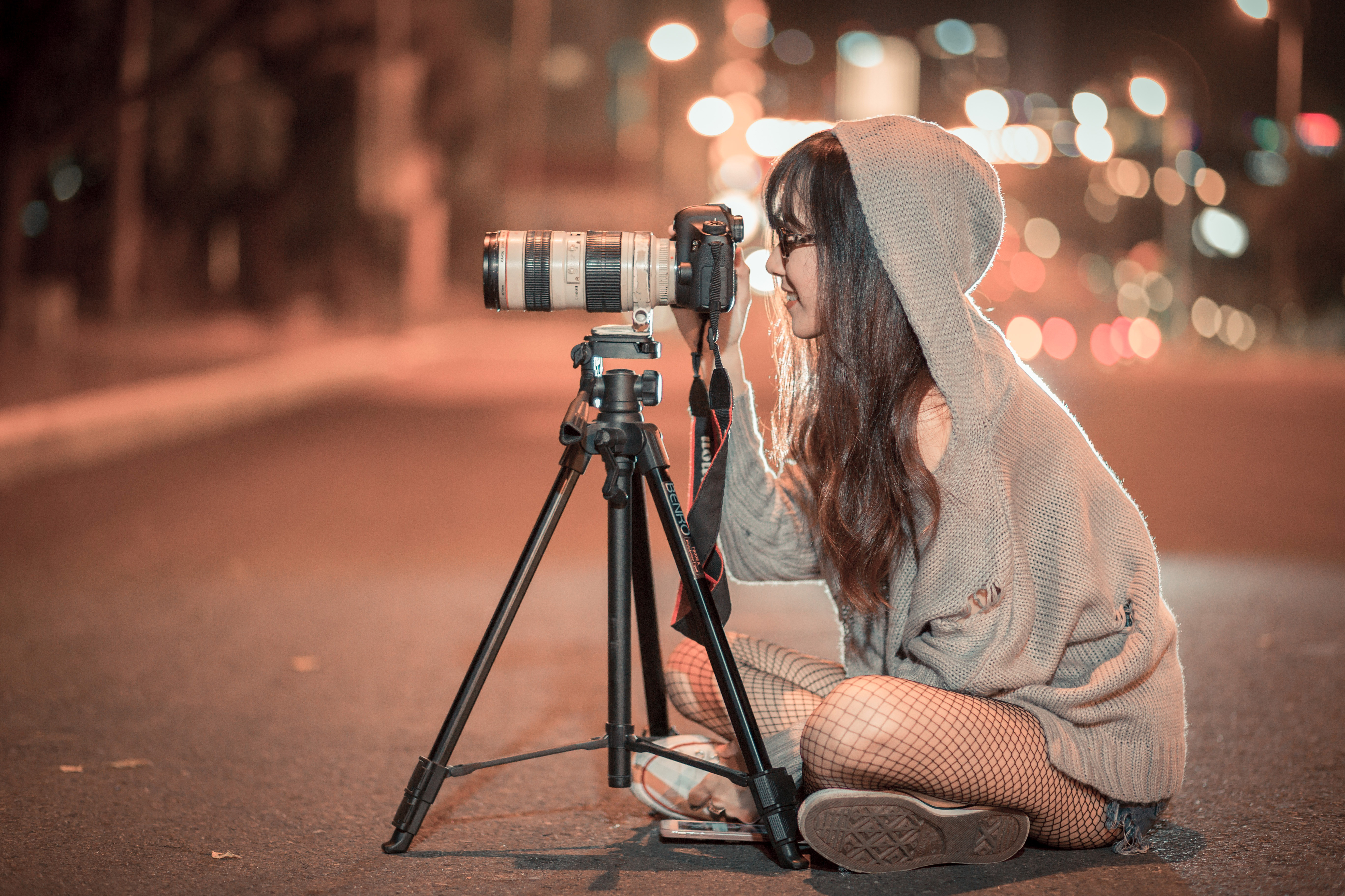 photographersittingontheroadtakingaphotoatnight image  Free 