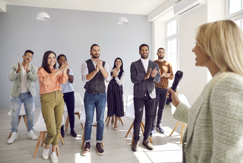 Happy Diverse Audience Giving Speaker Standing Ovation for Good