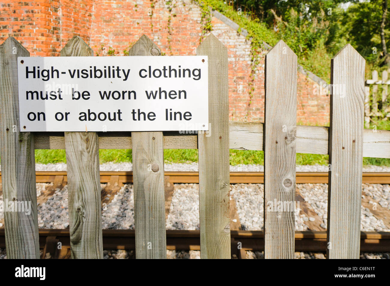 Sign by a private railway track warning statt to wear high visibility