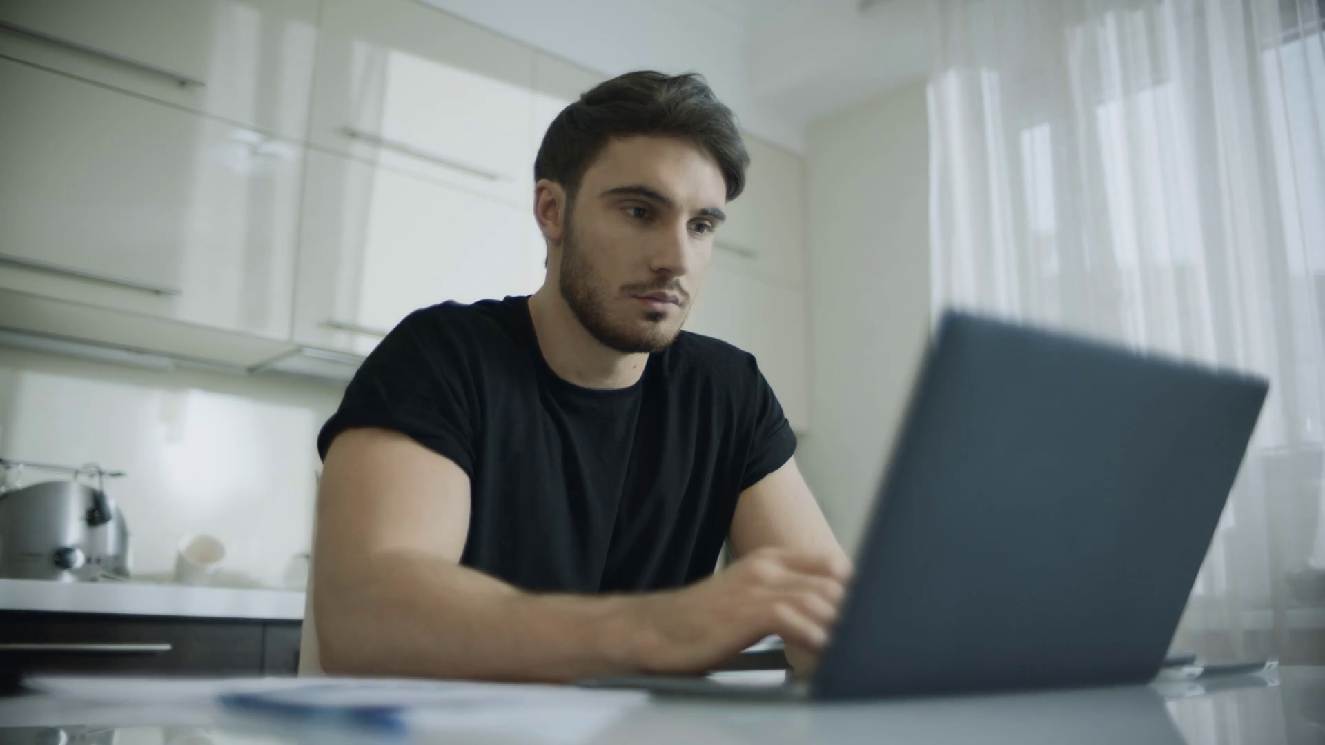 Man Using Laptop At Kitchen Table Stock Footage SBV333992895 Storyblocks