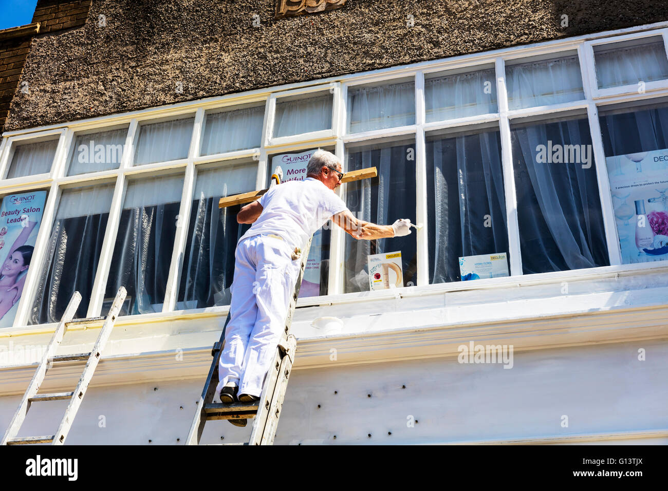 Man painting window painter decorator decorating paint woodwork frames 